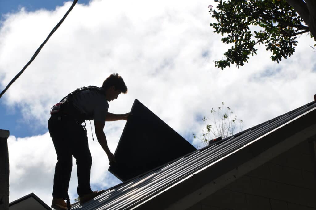 Silhouette of a solar panel installer for Sundance Power Systems